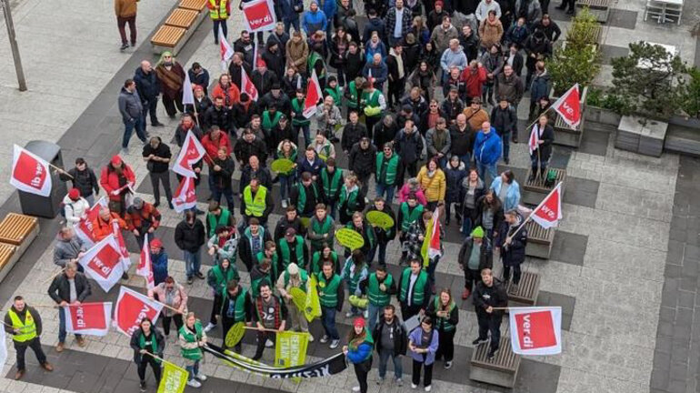 Luftaufnahme von demonstrierender Menschenmenge mit grünen Westen, roten und gelben verdi Fahnen am bundesweiten Jugendaktionstag in der Tarifrunde Telekom 2024